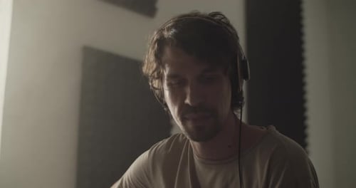 Young Adult Working on Music in Home Studio