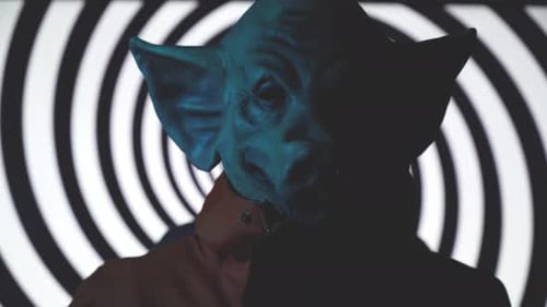 Creepy Man with Pig Mask with Psychadelic Rotating Spiral Background
