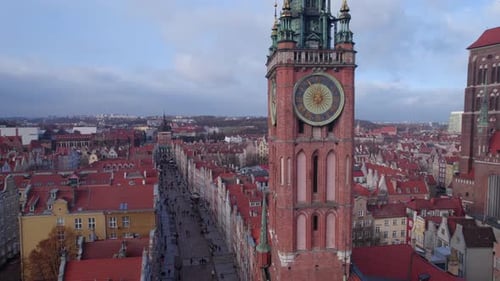 Aerial Shot of Ancient Cathedral and Clock Tower in European Town with Tiled Red Roofs