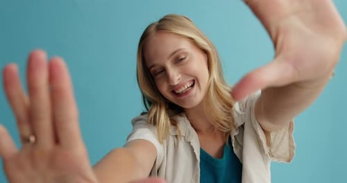 Smiling Blonde Woman Framing Face With Her Hands