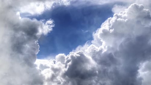 thick cumulus clouds in a clear blue sky.