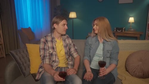 Couple Relaxing on Couch with Wine