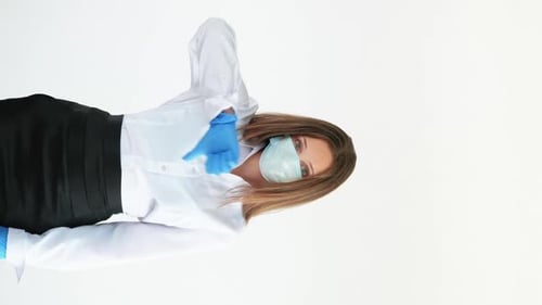 Woman With Mask Gesturing Thumbs Up and Down