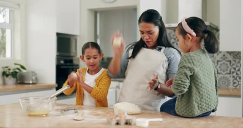 Woman and Children Making Dough Balls Together at Home