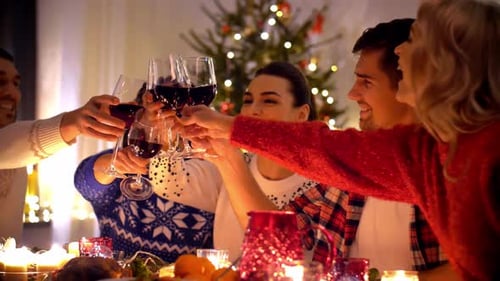 Friends Toasting Wine at Christmas Dinner Celebration