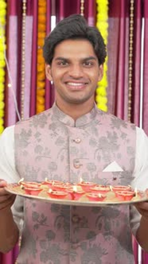 Young Man Holding Diwali Oil Lamps