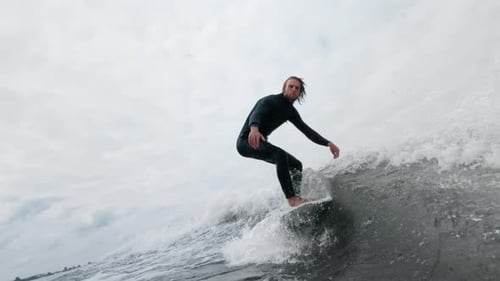 Surfer Skillfully Rides a Wave Showcasing Balance and Agility in Dynamic Ocean Scene