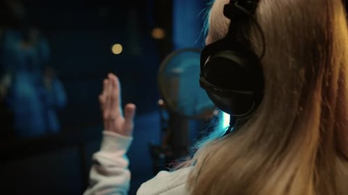 Blonde Woman Singing in Professional Recording Studio Voice Acting and Podcast Back View of Talented