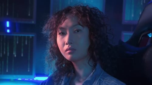 an asian woman programmer is working in her computer room