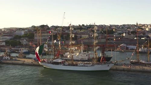 Sailing Ships Moored at Lisbon Port Ready for Race with Cityscape in Background
