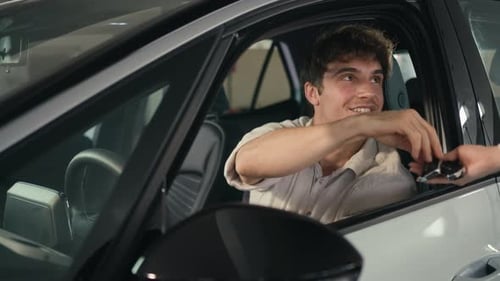 Smiling Man Receives Keys Inside Modern Car