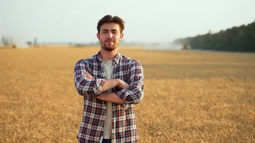 Portrait of Happy Farmer Standing in Ripe Wheat Field with Arms Crossing on Chest Proud Agronomist