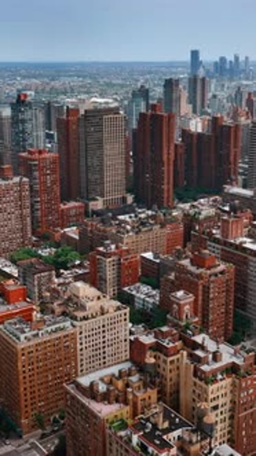 Immense urban landscape from top at daytime. Drone flight above the building with orange facades