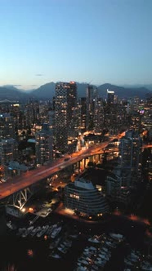 Downtown of Vancouver at Night Skyscrapers and Traffic on the Roads