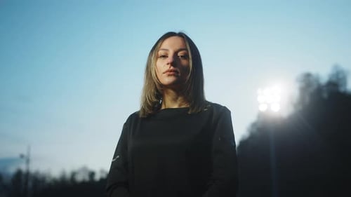 Beautiful young woman football player standing and looking at the camera