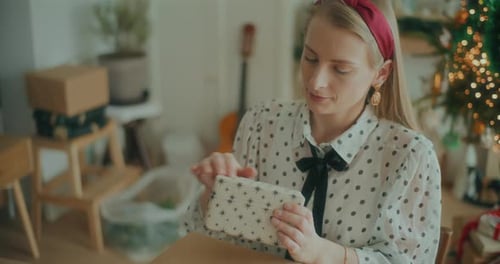 Joyful Woman Decorating Wrapping Christmas Gifts For Xmas Holidays