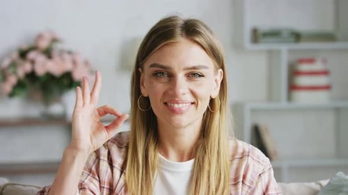 Woman Giving Ok Hand Gesture Smiling
