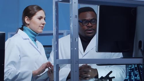 Scientists Discussing Computer Data in Modern Laboratory