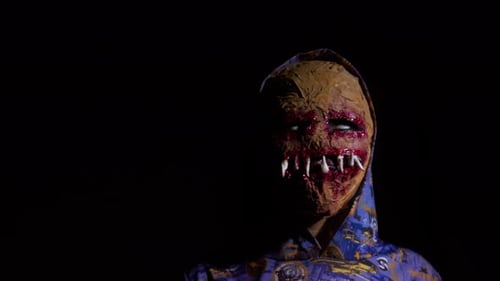 Horror face mask, young boy in dark area