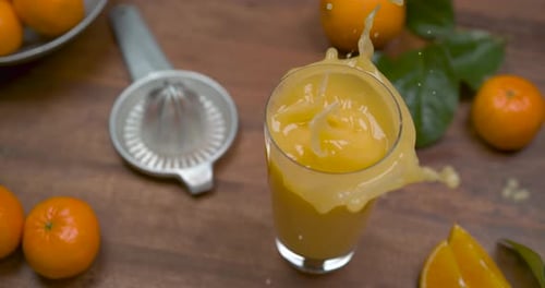 Orange Juice Splash: Refreshing Citrus Drink on Wood Table