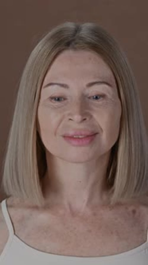 Portrait of Beautiful Senior Woman Posing with Smile in Studio