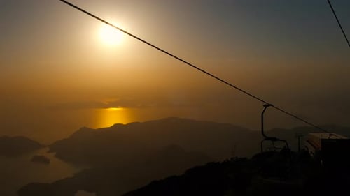 Tropical Mountain Sunrise with Ski Lift Silhouette
