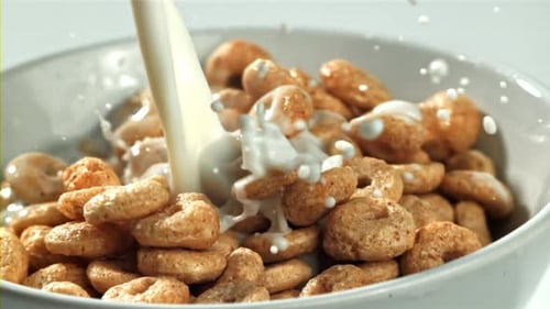 Milk Pouring into Bowl of Cereal