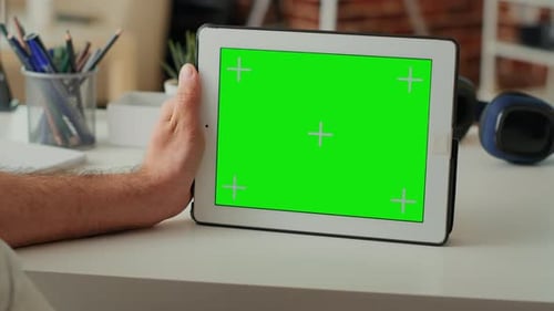 Adult Using Tablet with Green Screen in Office