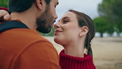 Smiling Couple Embrace Each Other Outside in Park