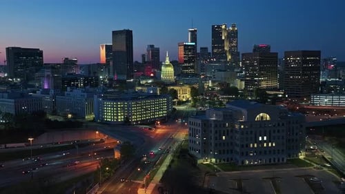 Atlanta Skyline lighting in warm lights at twilight.Aerial Panorama wide shot. Traffic scene on unde