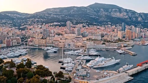 Boats Docked On The Water By A City Aerial