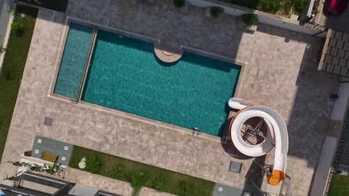 Aerial View Pool With a Big Water Slide Kids Enjoying a Splashy Ride