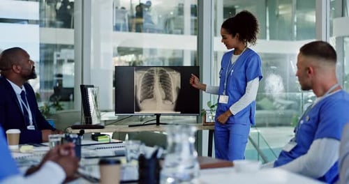 Medical Team Reviews X-Ray in Modern Office