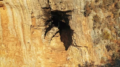 Sunlight Illuminating a Rocky Cave Entrance