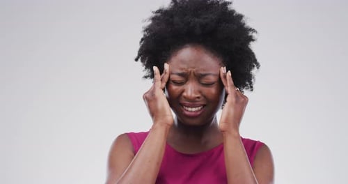 Woman Experiencing Headache With Hands on Temples