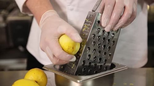 Close Up Grating Lemon Peel with Metal Grater