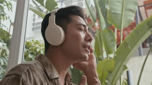 Man Singing Along to Music with Headphones
