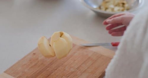 Woman Peels Apples In Kitchen