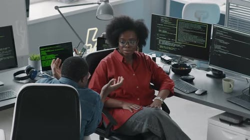 Black Couple of Programmers Talking in Office