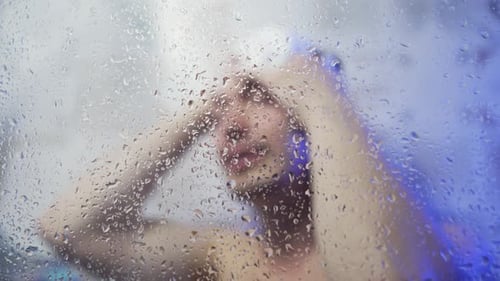 Man Washing Hair in Shower Water Droplets and Steam Around