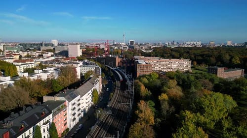 city Train tracks over river bridge, colorful fall. Great aerial view flight drone