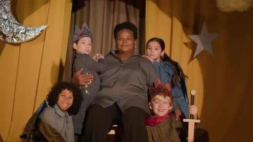Senior Director And Child Actors On Stage