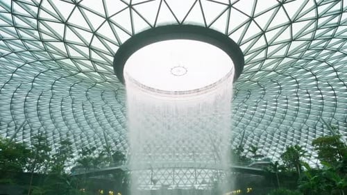Magnificent vortex with a waterfall inside architecture at Singapore airport.