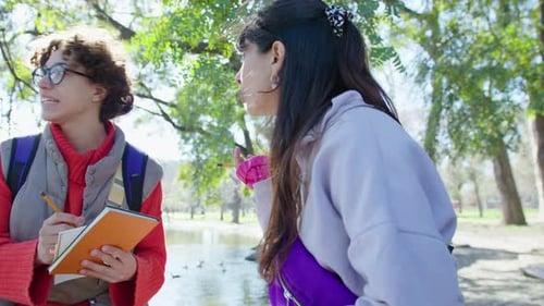 High School Friends Chatting and Doing Homework in Park