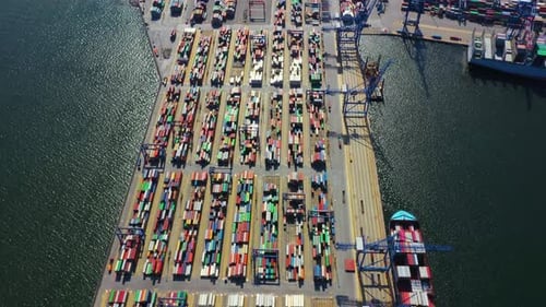 Container ship in export and import business and logistics. Shipping cargo to harbor by crane. Water