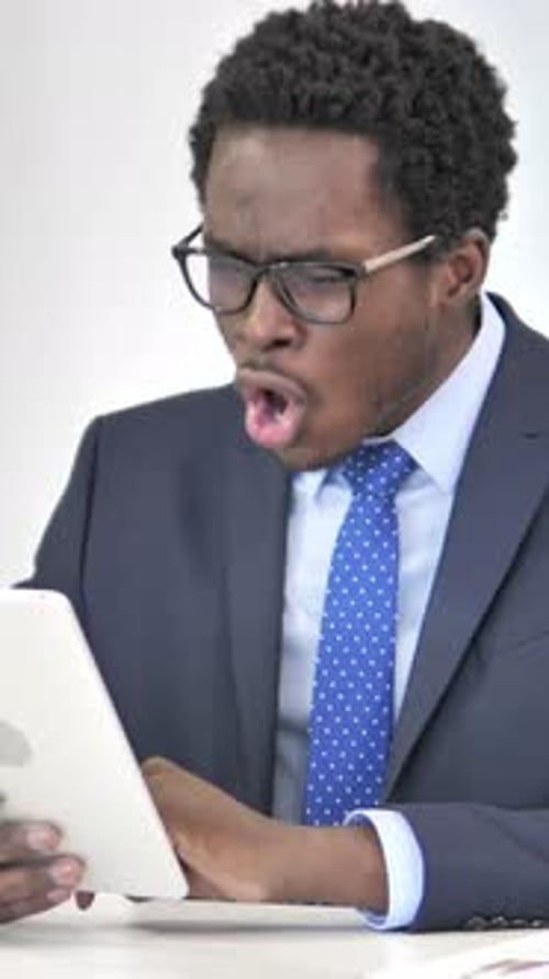 African Businessman Reacting to Financial Loss on Tablet, Vertical Video