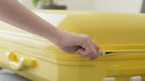 Bright Yellow Suitcase Opening for Travel Packing