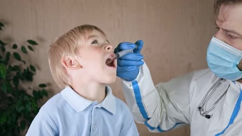 Doctor Giving Medicine to a Young Boy