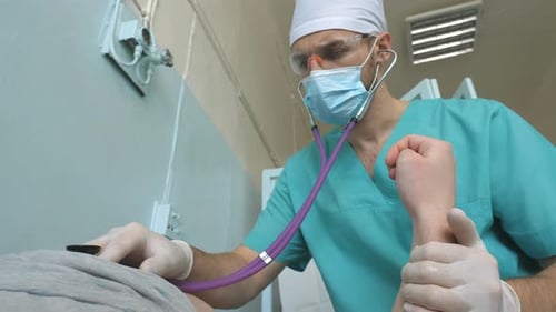 Medical Professional Checking Patient With Stethoscope