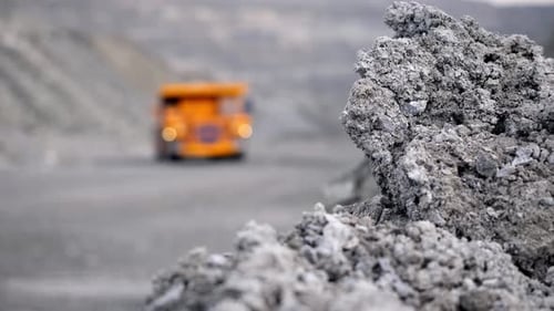Heavy Mining Equipment Operates on a Challenging Rocky Terrain for Various Purposes and Industries
